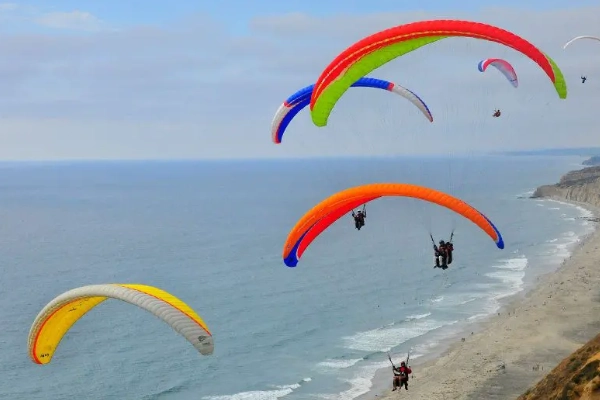 Paragliders launching from the cliffs at Torrey Pines Gliderport