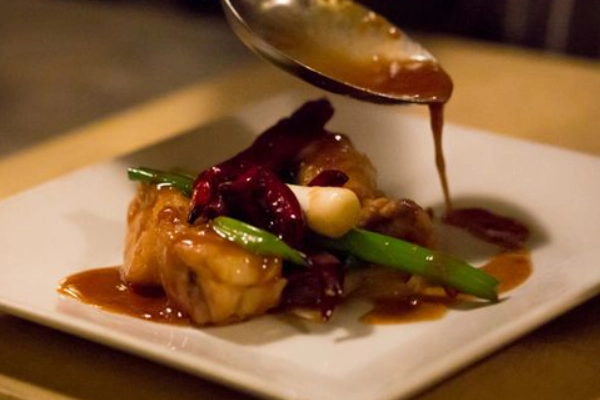 A plate of pork belly tacos from The Refinery