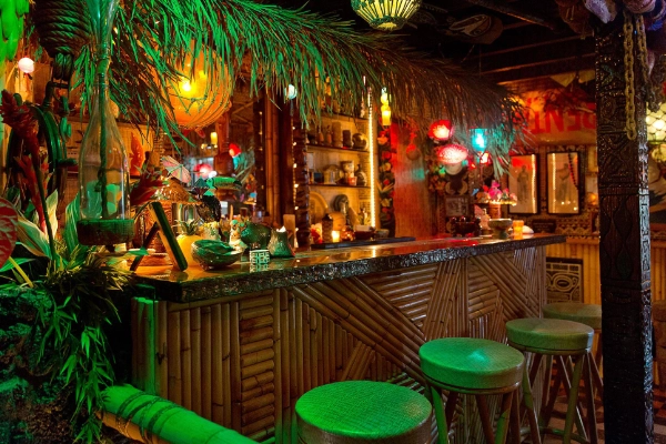 The retro interior of the hidden tiki bar at The Coupe
