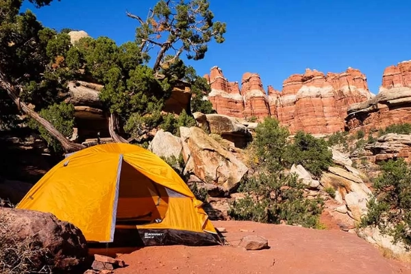 A backpacker's tent set up in a remote backcountry location