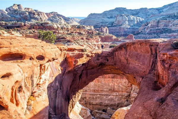 Hikers near Cassidy Arch, named after the outlaw Butch Cassidy
