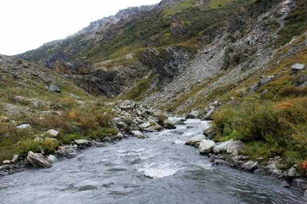A hiker on a trail alongside the winding Savage River
