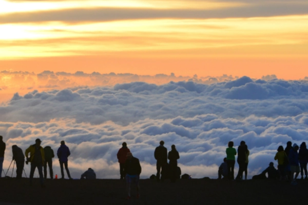 A spectacular sunrise above the clouds from the summit of Haleakalā
