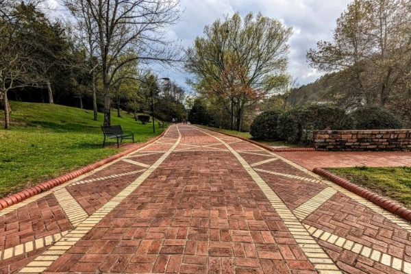 A shady brick pathway on The Grand Promenade