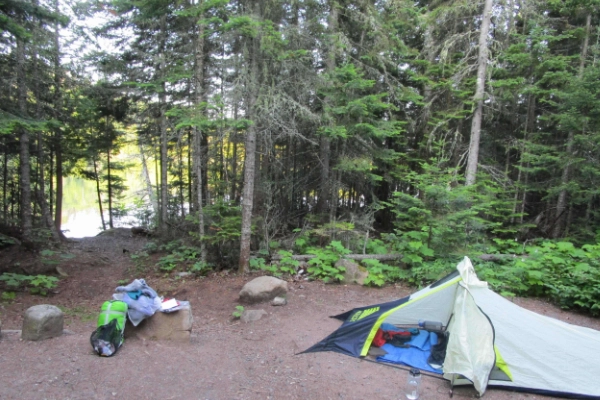 A tent at a backcountry campsite with a view of Lake Superior