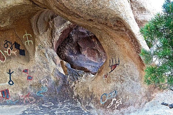 The historic Barker Dam holding water with petroglyphs nearby