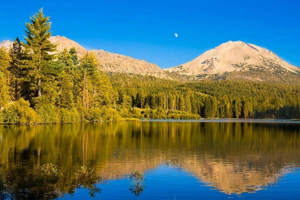 A perfect reflection of Lassen Peak in the calm waters of Manzanita Lake
