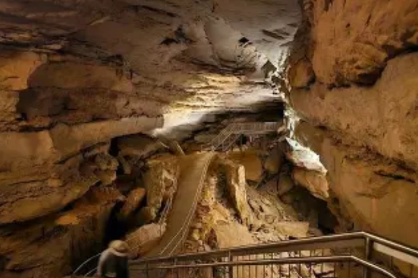 A dramatic cave chamber with dripping stalactites