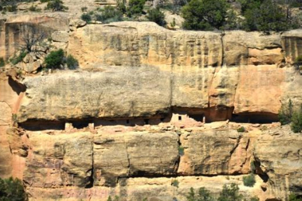 A scenic road winding along the mesa top with overlooks of archaeological sites