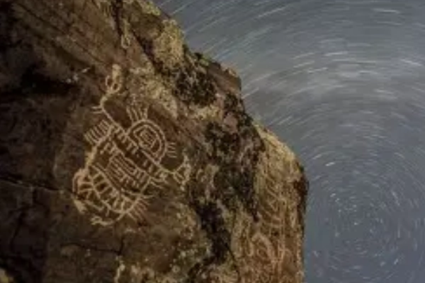 Ancient Skagit rock carvings of salmon and spirits by a lake