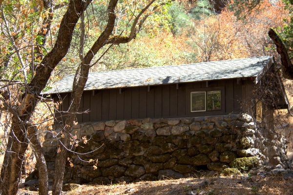 A small, historic cabin with pioneer-era odds and ends inside