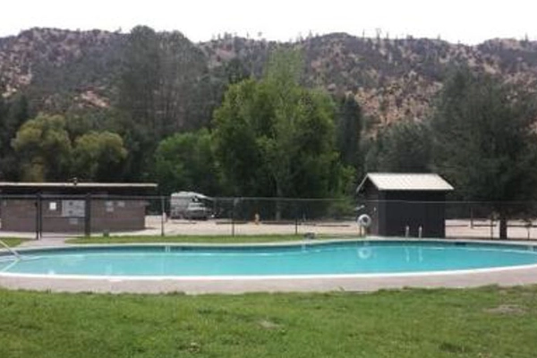 An RV resort with a swimming pool on a hot day