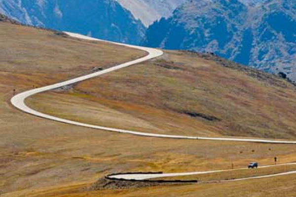 A winding road through the high alpine tundra with panoramic mountain views
