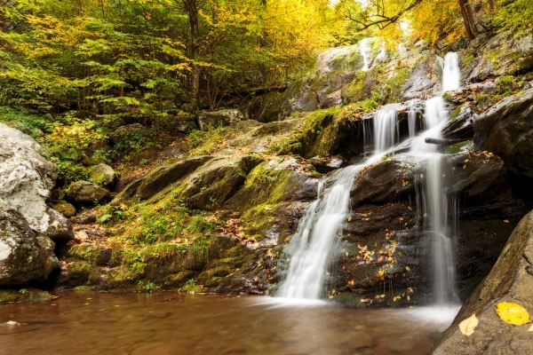 A beautiful waterfall cascading down rocks on a short hiking trail