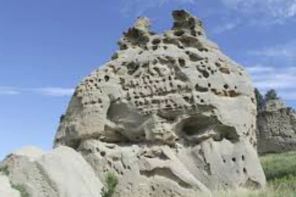 Ancient Lakota carvings of bison and spirits etched into sandstone