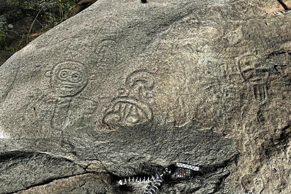 Ancient Taíno carvings of faces and spirits etched into volcanic rock