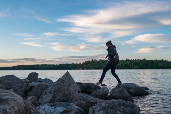 A peaceful hiking trail through wetlands with large glacial erratic boulders