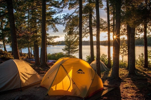 A classic tent spot in a campground right on a lake