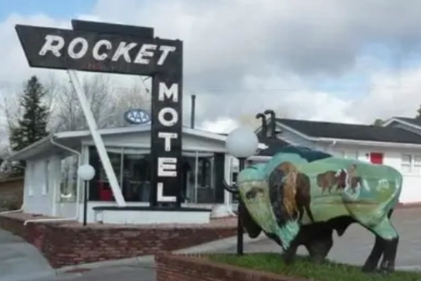 A retro-style motel with a quirky, charming neon sign