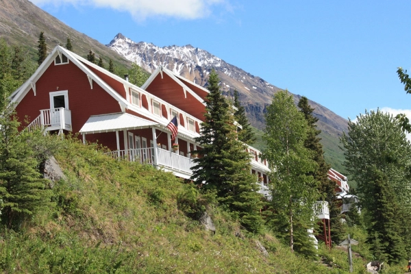 A plate of grilled salmon served in a dining room with glacier views