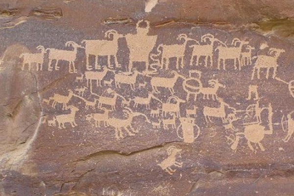 Ancient Shoshone carvings of bison and spirit symbols on a rock face
