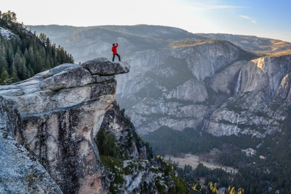 A stunning, panoramic view of Yosemite Valley, Half Dome, and waterfalls from a high vantage point